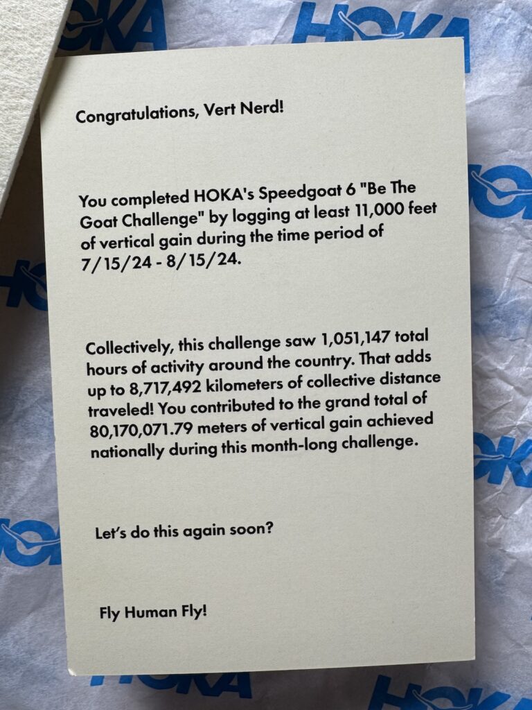 Strava Marketing - Hoka "Be the Goat Challenge: Vertical" mailer contents: pennant flag, sticker, postcard, large branded mailer